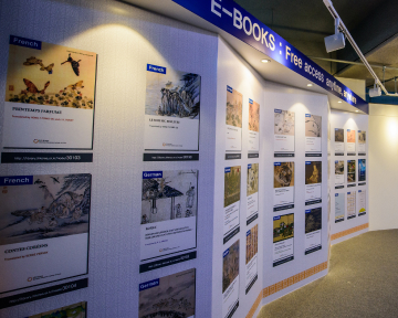 Wall display of e-books with free access signs.